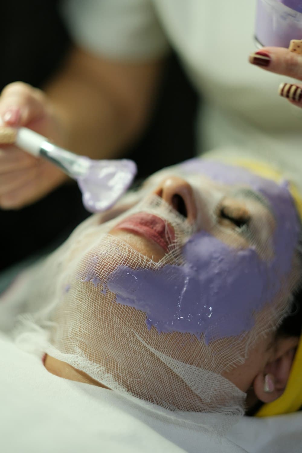 A face mask being applied with a brush during a facial